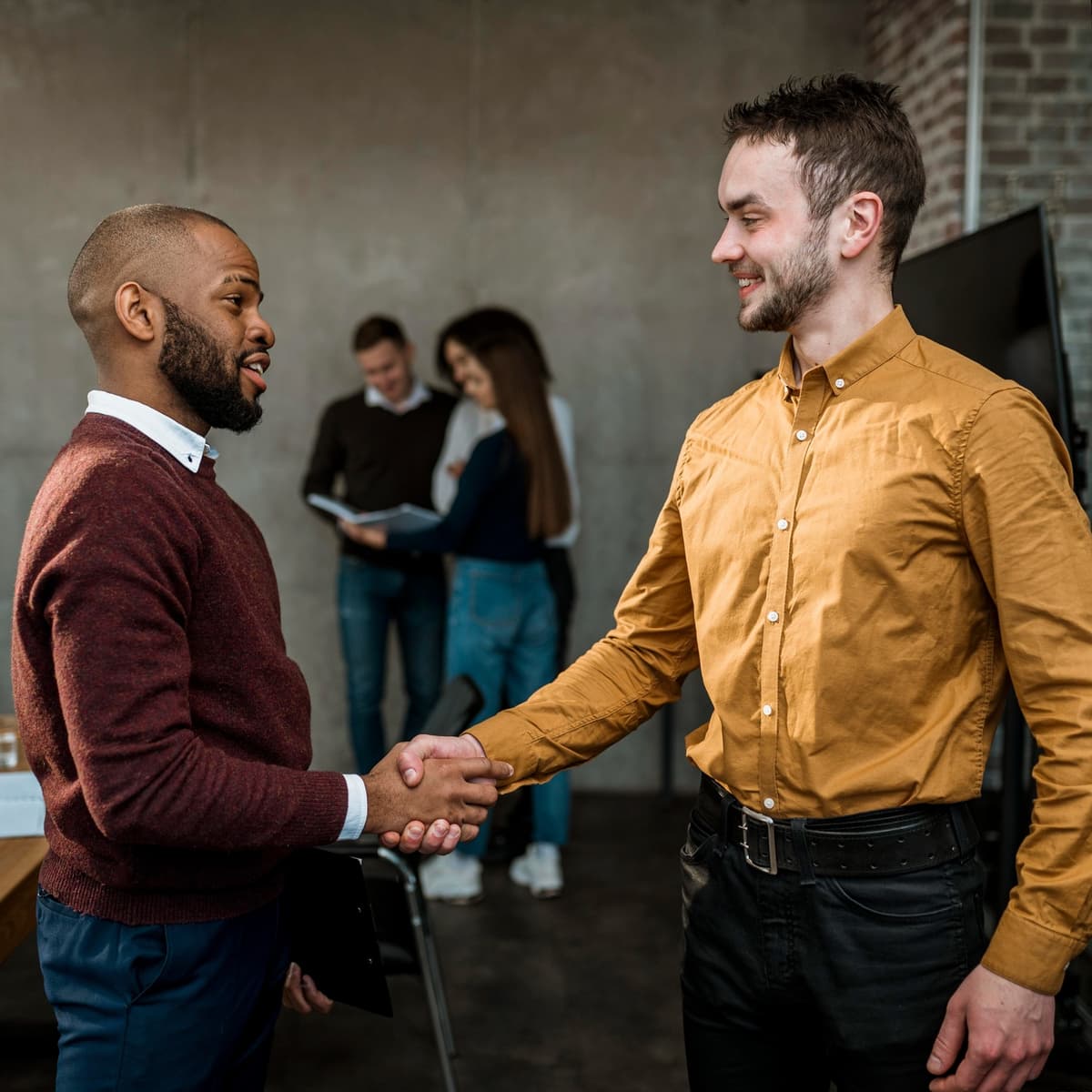 Two business partners shaking hands, representing the BizOS Partner Program